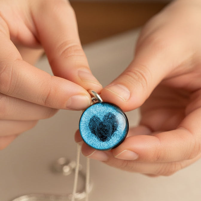Necklace with a round pendant featuring a fingerprint design shaped into a heart